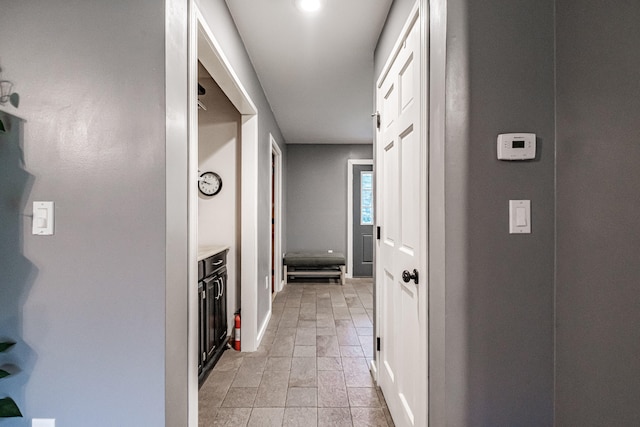 hall with light tile patterned floors