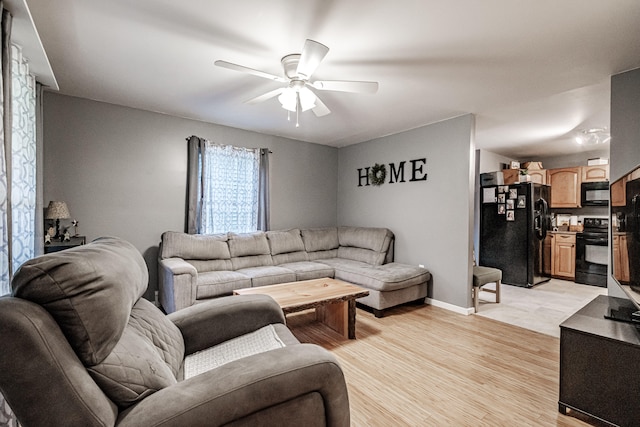 living room featuring light hardwood / wood-style flooring and ceiling fan