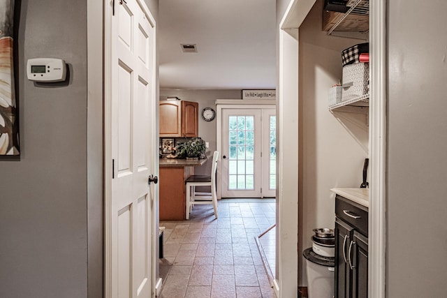 hall featuring light tile patterned floors