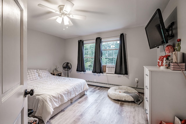 bedroom featuring ceiling fan, light hardwood / wood-style floors, cooling unit, and baseboard heating