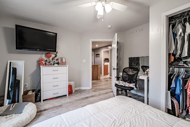 bedroom with ceiling fan, a closet, and light hardwood / wood-style floors