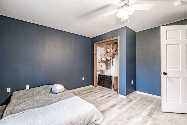 bedroom with a closet, ceiling fan, and light hardwood / wood-style floors