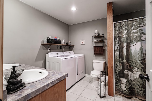 bathroom featuring tile patterned flooring, toilet, separate washer and dryer, and vanity