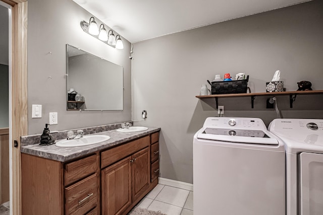 bathroom featuring tile patterned floors, washing machine and dryer, and dual bowl vanity