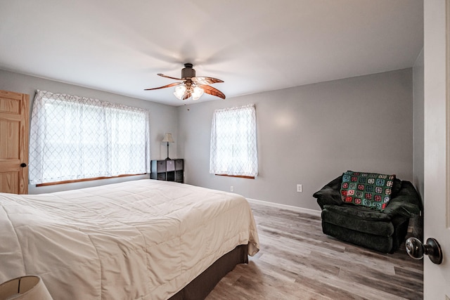 bedroom with light hardwood / wood-style floors and ceiling fan