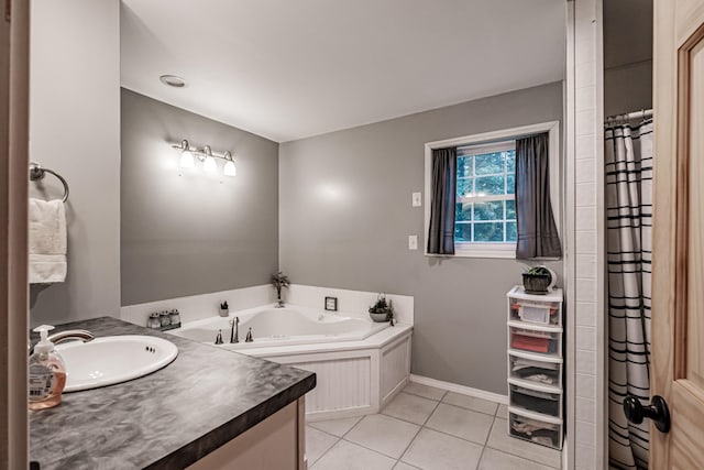 bathroom featuring tile patterned flooring, vanity, and a tub to relax in