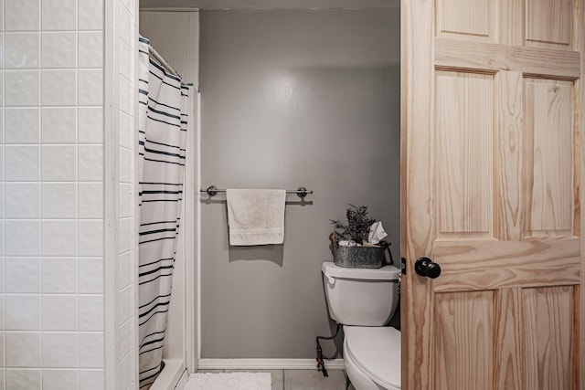 bathroom featuring tile patterned floors, walk in shower, and toilet