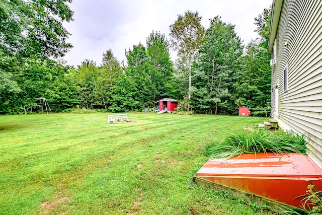 view of yard featuring a wooden deck and a shed