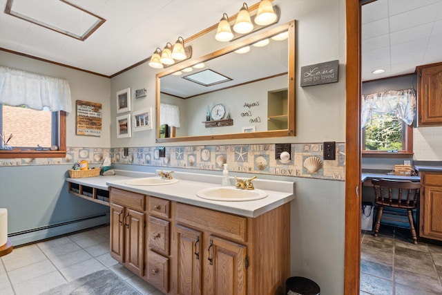 full bathroom with double vanity, a sink, baseboard heating, and crown molding