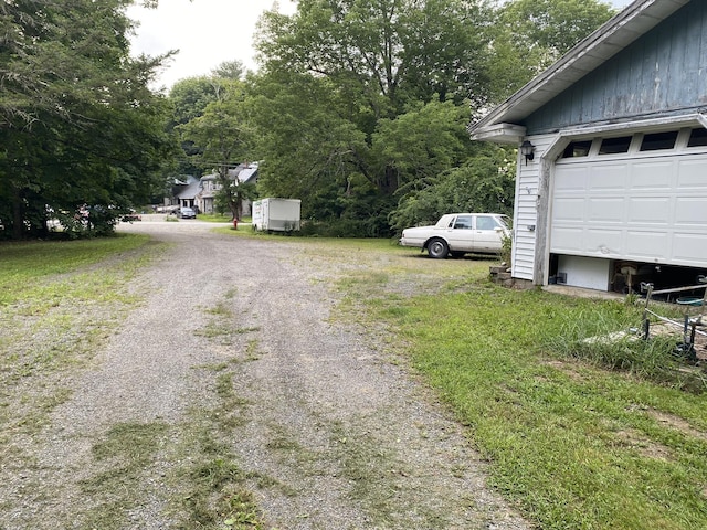 view of street with gravel driveway