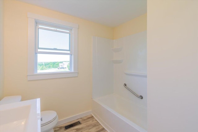 full bathroom with vanity, shower / bathing tub combination, hardwood / wood-style floors, and toilet