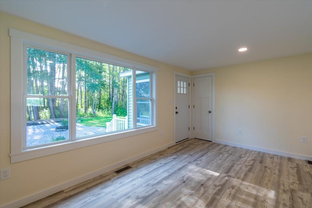 spare room with light hardwood / wood-style flooring