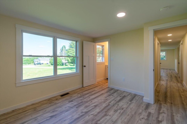 unfurnished room with light hardwood / wood-style flooring