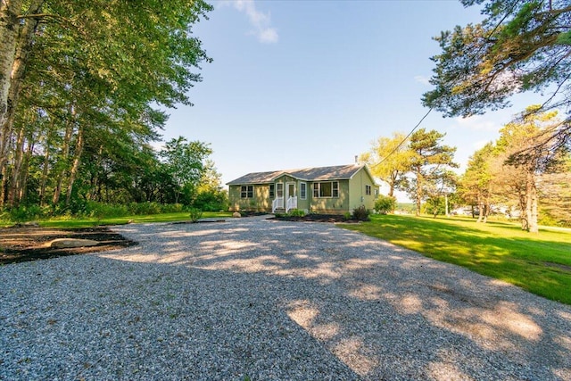 ranch-style home featuring a front yard