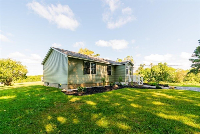 rear view of property with a lawn