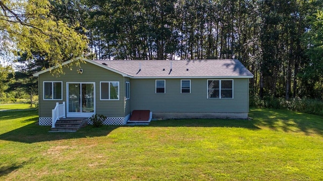 rear view of house with a yard