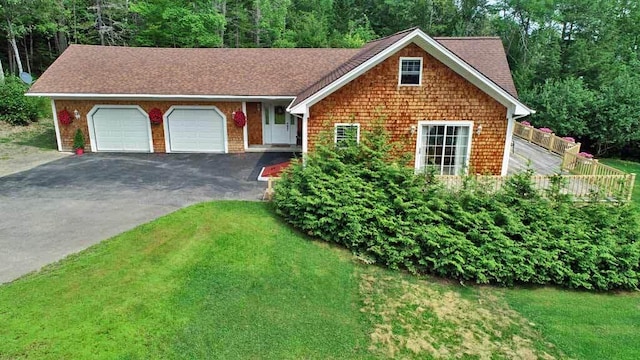 view of front of property with a front lawn and a garage