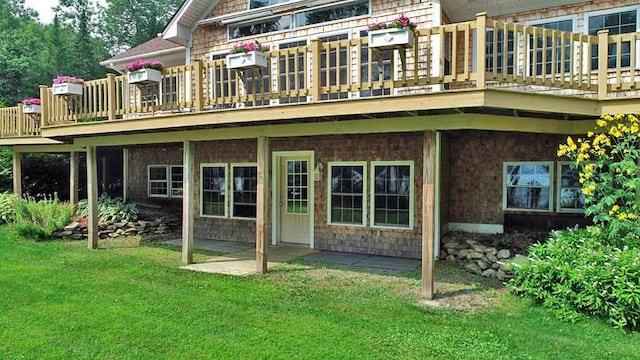 rear view of house featuring a yard and a wooden deck