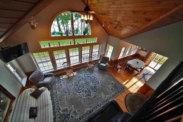 living room featuring wood-type flooring, ceiling fan, high vaulted ceiling, wooden ceiling, and beamed ceiling