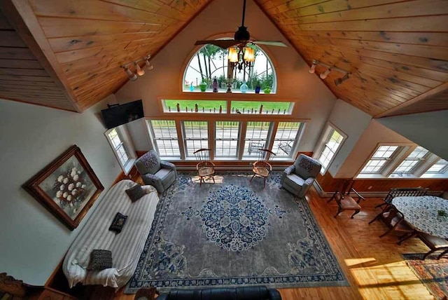 living room featuring plenty of natural light, hardwood / wood-style floors, high vaulted ceiling, and wooden ceiling