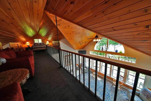 interior space featuring carpet, lofted ceiling, and wooden ceiling