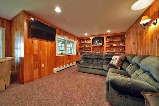 carpeted living room with a baseboard heating unit and wood walls