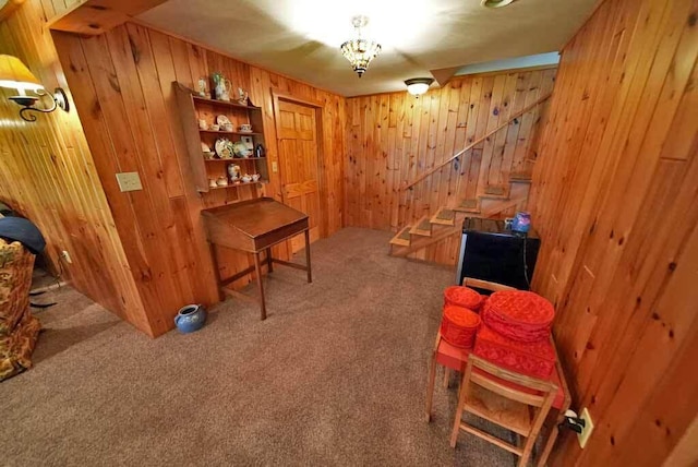 interior space featuring carpet flooring and wood walls