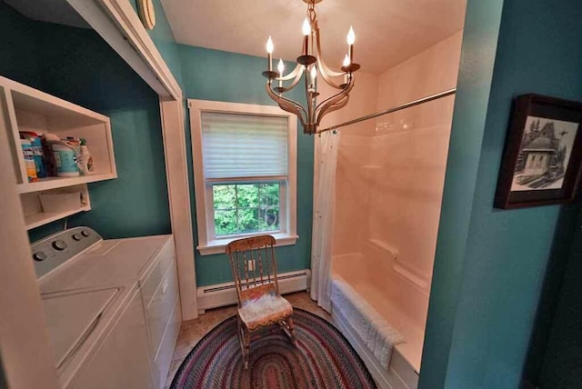 clothes washing area featuring a chandelier, washer and clothes dryer, and baseboard heating