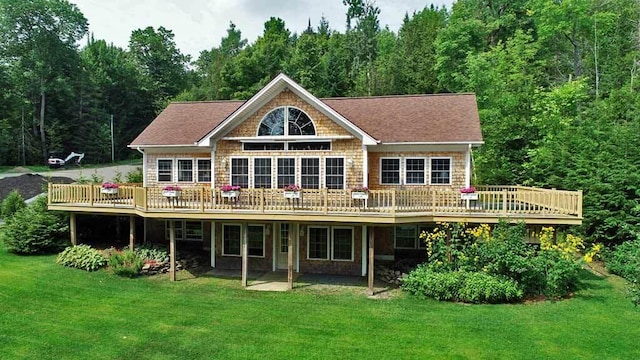 rear view of house featuring a yard and a wooden deck