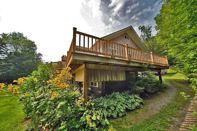 rear view of property featuring a wooden deck