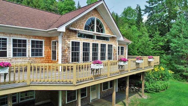 back of house featuring a yard and a wooden deck