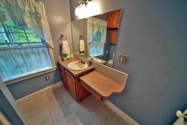 bathroom with vanity, toilet, and tile patterned floors