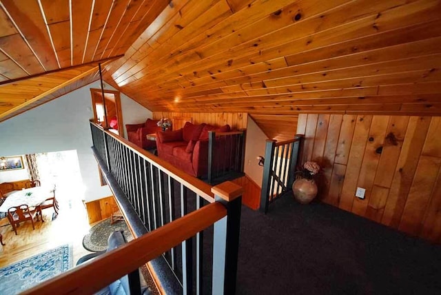 bonus room featuring vaulted ceiling, wood ceiling, carpet flooring, and wood walls