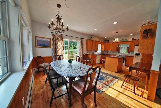 dining space featuring an inviting chandelier and light hardwood / wood-style flooring