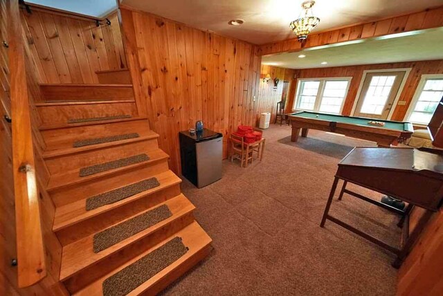 recreation room with billiards, carpet floors, and wood walls