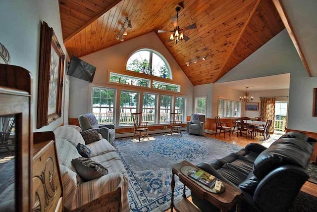 living room with wood ceiling, high vaulted ceiling, hardwood / wood-style floors, rail lighting, and ceiling fan with notable chandelier