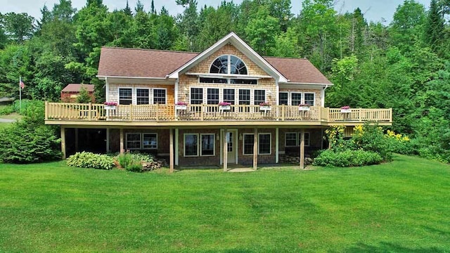 back of property with a yard and a wooden deck