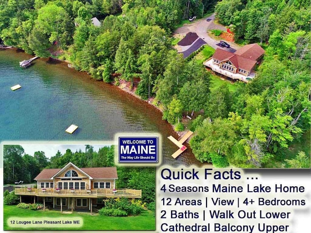 birds eye view of property with a water view and a wooded view