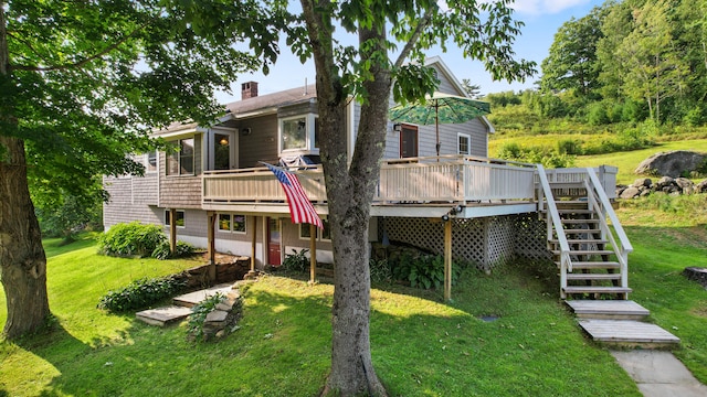 view of front of home featuring a deck and a front lawn