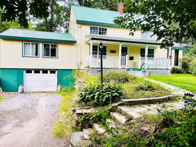 view of front of home featuring covered porch and a garage