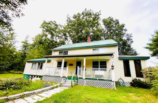 view of front of property with a porch and a front lawn