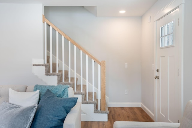 entryway featuring stairway, baseboards, wood finished floors, and recessed lighting