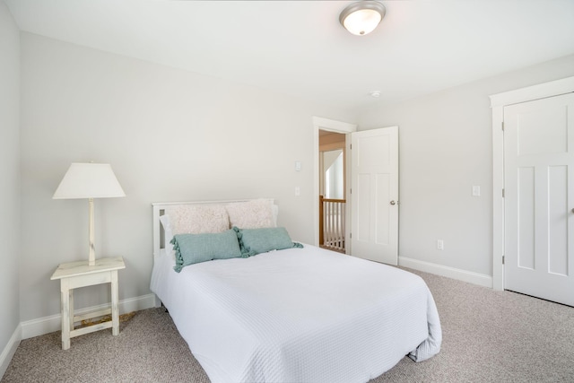 carpeted bedroom featuring baseboards