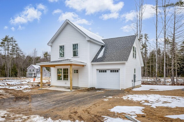 view of front of property featuring roof with shingles and an attached garage