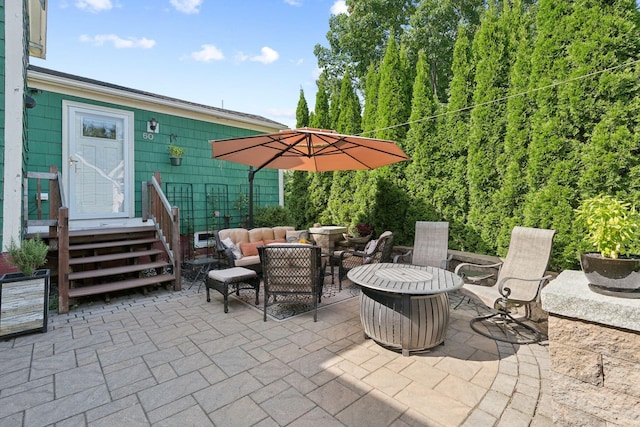 view of patio featuring an outdoor living space with a fire pit