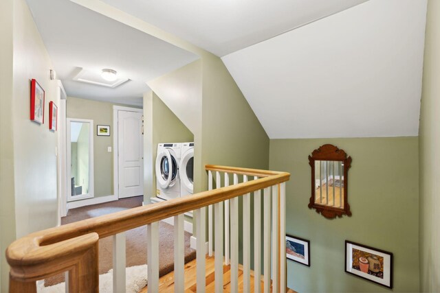 corridor featuring lofted ceiling and washing machine and dryer