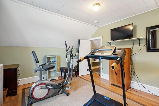 workout room with lofted ceiling and wood-type flooring