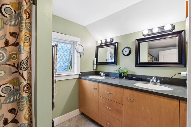 bathroom featuring tile patterned floors, a shower with curtain, lofted ceiling, and vanity