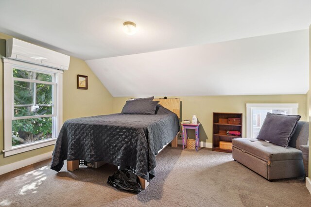 carpeted bedroom with vaulted ceiling and a wall mounted air conditioner