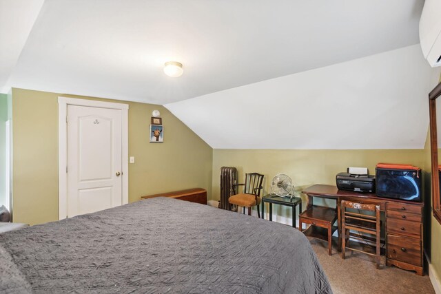 carpeted bedroom with lofted ceiling and a wall mounted AC